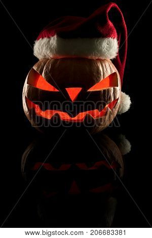 The Concept Of Halloween And The New Year And Christmas. The Evil Scary Pumpkin Santa In The Santa C