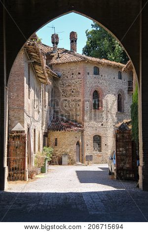 Old buildings in courtyard of ancient castle in Grazzano Visconti Italy