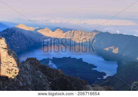 View from mountain Rinjani Summit at sunrise time. Mountain Rinjani at Lombok, Indonesia.