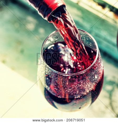 Pouring Red Wine. Wine In A Glass, Selective Focus, Motion Blur,