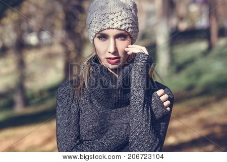 Young Blonde Woman Standing In A Park With Autumn Colors