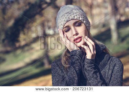 Young Blonde Woman Standing In A Park With Autumn Colors