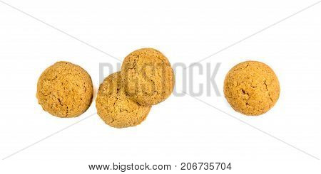 Four Scattered Ginger Nuts In A Row Seen From Above