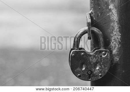 iron lock hanging on the iron fence