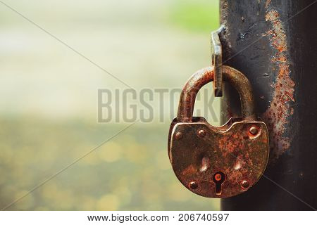 iron lock hanging on the iron fence