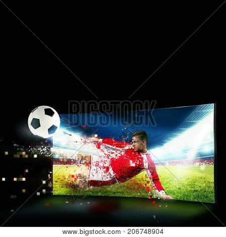 Soccer player comes out of the tv to kick the ball