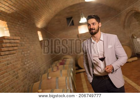 Oenologist tasting wines in wine grower cellar