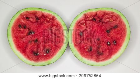 Two halves of a watermelon on a white background