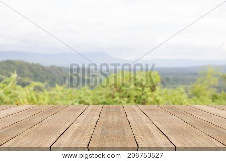 Empty wooden table top on blurred background at phu pa por mountian,space for montage products
