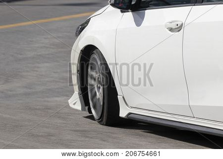 white car turning on the road .