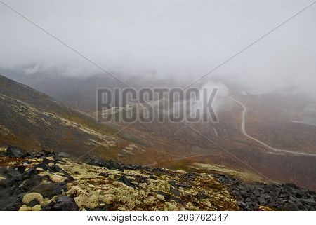 Thick fog in mountains. Autumn in tundra. Lapland