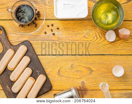 Image on top of table with savoyardi cookies, coffee, cream cheese. Place for text