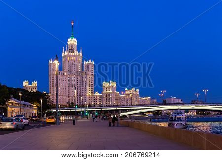 Moscow Russia - September 24 2017: Moskvoretskaya embankment overlooking the Stalin high-rise skyscraper in Moscow at sunset in the evening illumination.