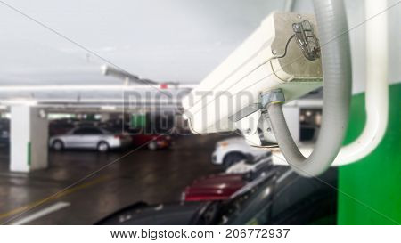 Security equipment concept. Closeup CCTV camera monitoring in the cars park. CCTV camera surveillance on car parking Safety system area control with copy space.