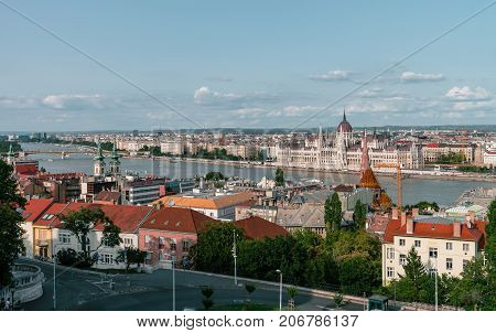 Panoramic view on the Hungarian Parliament Building on the bank of the Danube in Budapest. Sunny evening with clouds