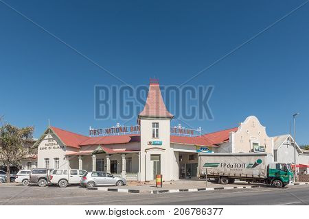 KARIBIB NAMIBIA - JULY 3 2017: A street scene with a shopping centre in an historic building and vehicles in Karibib a small town in the Erongo Region of Namibia.