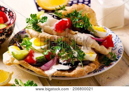 pita sabich sandwich with hummus and vegetables..selective focus