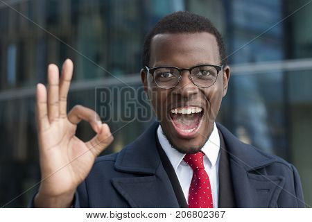 Portrait Of African American Business Man Smiling And Showing Okay Sign. Body Language Concept