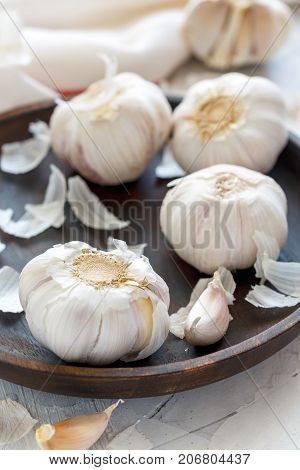 Garlic, Cloves And Peel On A Wooden Dish.