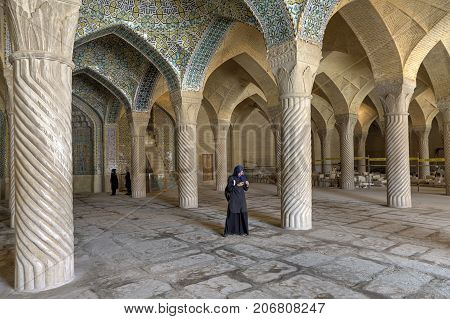 Fars Province Shiraz Iran - 19 april 2017: The tourist attraction of the Iranian city of Shiraz Vakil mosque vaulted ceilings and monolithic carved columns of prayer hall are visited by tourists.