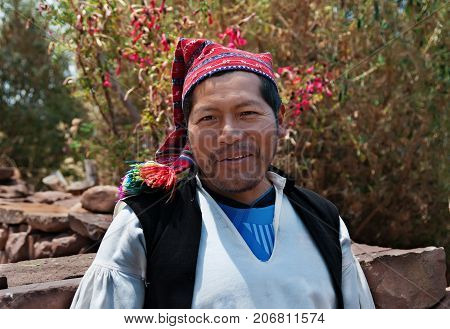 PUNO, PERU - OCTOBER 1, 2017: Portrait of a Native Peruvian man wearing typical hat.