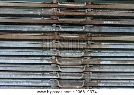 rusty iron metal plates front view with handle for industrial use and gardening