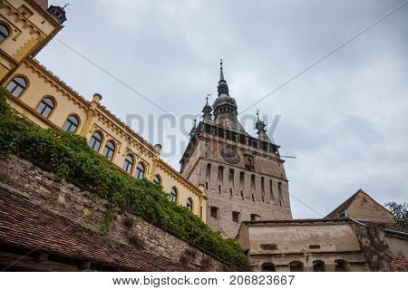 Sighisoara Clock Tower (Turnul cu Ceas) during a cloudy fall afternoon. It is the main entrance of Sighisoara castle in Romania birthplace of Vlad Tepes aka Dracula