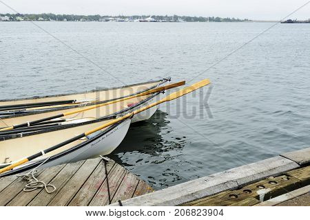 New Bedford Massachusetts USA - September 23 2017: Whaleboats from Buzzards Bay Rowing Club awaiting next training session on the Acushnet River