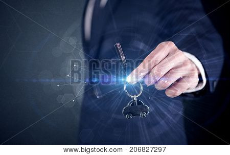 Businessman in suit holding over a key with connection concept around