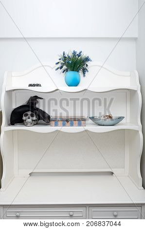 Human skull in a white cabinet. Halloween theme