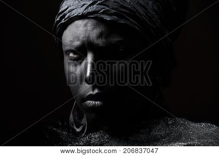 Female African voodoo shaman. Horizontal close-up photo