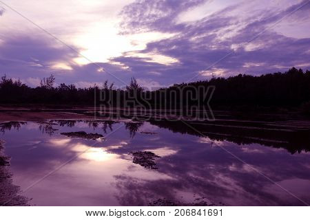 Mirror of purple sky in the morning reflection to the water Thailand.