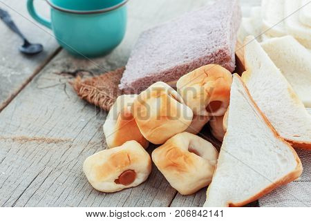 Baked Bread And Coffee Cup On Wooden Floor.