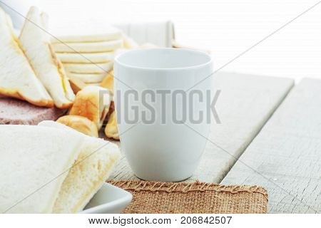 Cup of coffee and bread on the table.