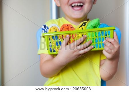 The Child Keeps His Things. The Boy Puts The T-shirts In A Drawer.