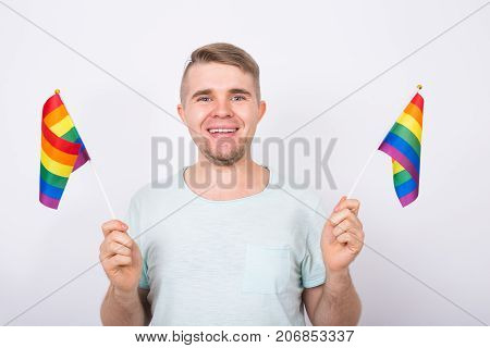 Young man hold a rainbow flag, gey boy.