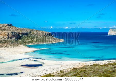 Amazing view of Balos Lagoon with magical turquoise waters, lagoons, tropical beaches of pure white sand and Gramvousa island on Crete, Greece