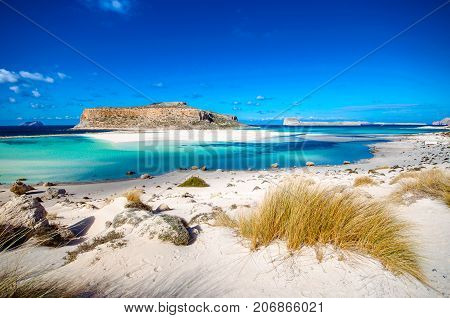 Amazing view of Balos Lagoon with magical turquoise waters, lagoons, tropical beaches of pure white sand and Gramvousa island on Crete, Greece
