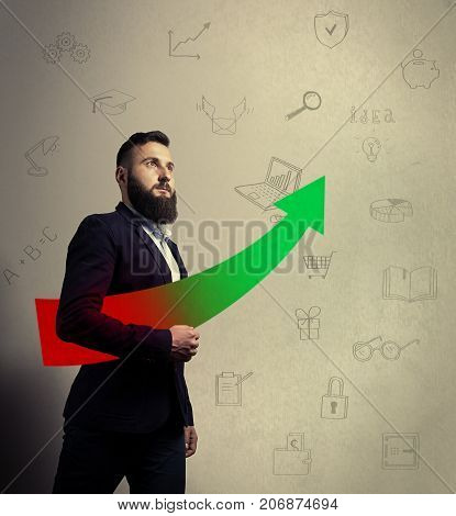 Bearded man in a business suit is holding a arrow icon in his hands. Background with hand-drawn illustrations on a business theme. Concept of financial growth success.