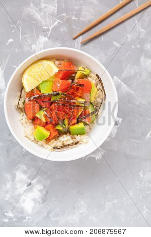 Hawaiian fish poke bowl with rice and avocado.