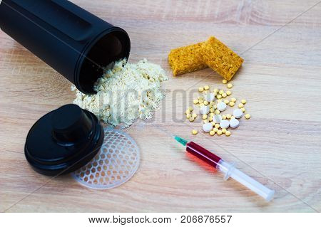 Sport nutrion supplements, pills, syringe and protein powder
