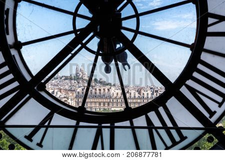 PARIS, FRANCE -JUNE 11, 2017: Famous clock in the Orsay Museum with Sacr -C ur in distance, Paris, France.
