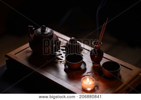 Tea ceremony with candles in the evening