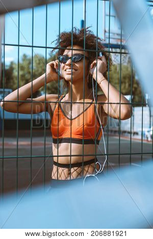 African-american Woman Listening To Music In Headphones