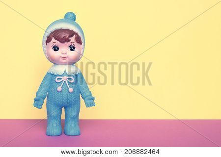 Cute vintage Japanese blue plastic doll on pastels color background with room for copy.