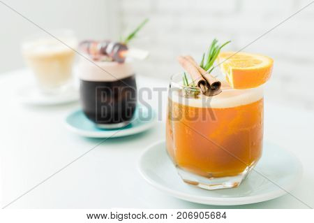 Selective focus of cocktails or mocktails with fruits in glasses.Traditional summer drink alcoholic cocktail with orange and grape in vintage restaurant