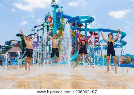 Pattaya Thailand - 1 May 2016 - Children jump up happily at a water fountain at Cartoon Network Amazone Water Park in Pattaya Thailand on May 1 2016.