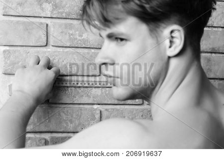 Man With Naked Body Holds Yellow Self Retracting Tape Measure