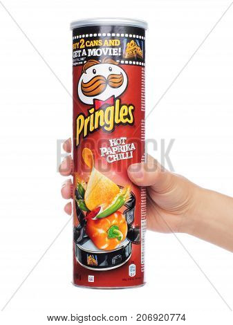 Kiev Ukraine - September 4 2017: Pringles original potato chips box in woman hand on white background. Pringles is a brand of potato snack chips owned by the Kellogg Company