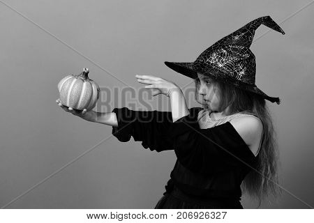 Girl With Carved Orange Pumpkin Isolated On Green Background